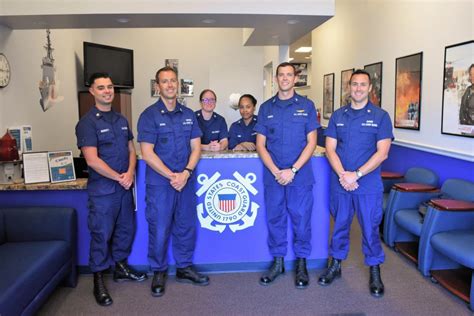 A Coast Guard recruiter speaking with potential recruits