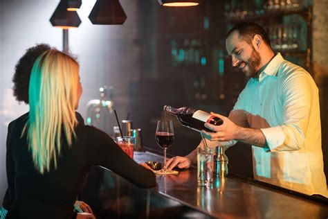 Bartender pouring a glass of wine