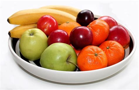 Person enjoying a fruit bowl with a happy expression