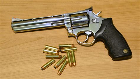 Image of a revolver on a wooden table