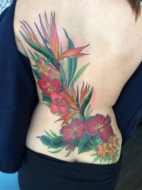 A bird of paradise flower tattoo on the neck