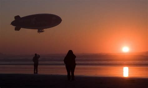 A blimp flying over a beach