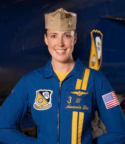 Blue Angels pilots standing in front of an F/A-18 Hornet