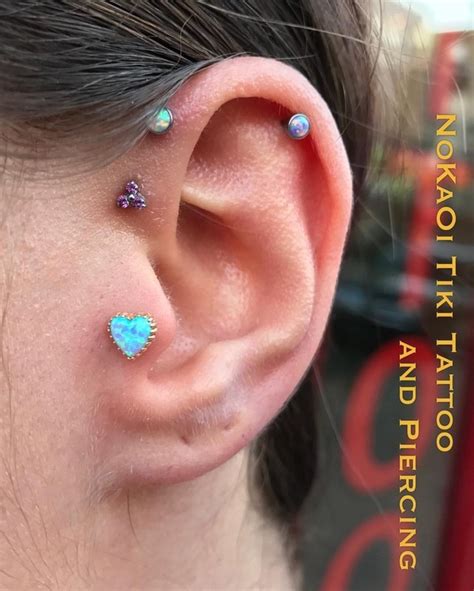 Blue body piercing with tattoo