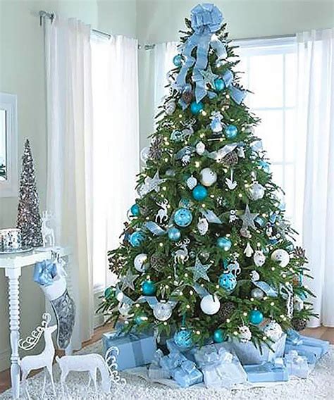 A blue Christmas tree decorated with white and silver ornaments