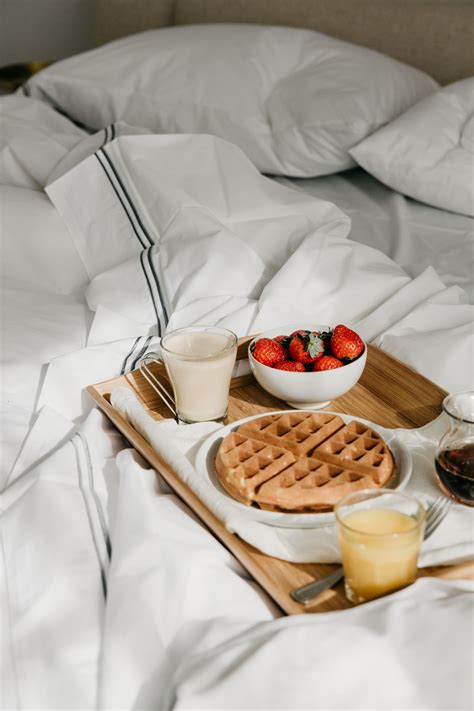 Breakfast in bed with fresh flowers and a delicious meal