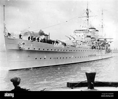 A British cruiser in harbor, preparing for deployment