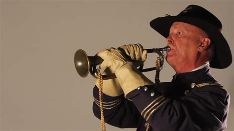 A bugle player in action, playing at a concert