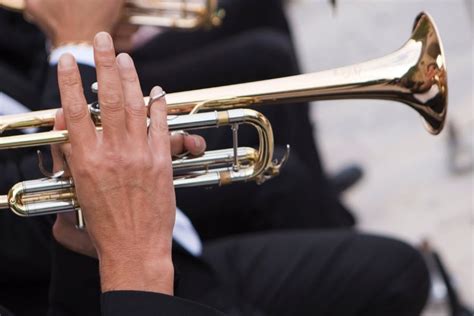 A person holding a bugle, with a thought bubble indicating the benefits of playing the instrument