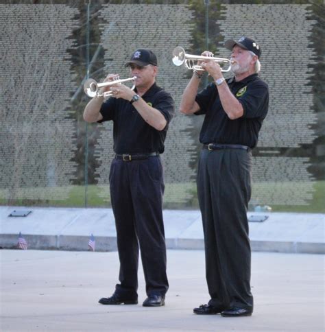 A bugle player performing indoors, in a concert hall