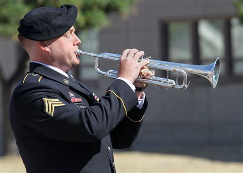 A military bugle player in a parade