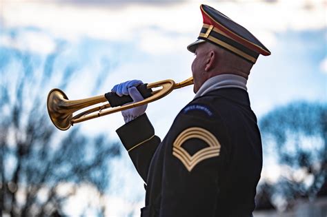 A bugler playing a call to post at a horse racing event