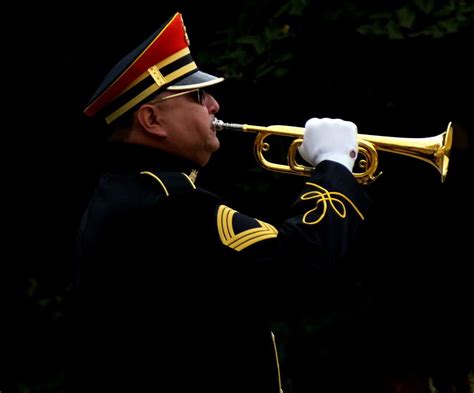 A bugler playing Taps at a funeral