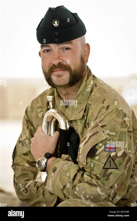 A bugler standing at a horse racing event