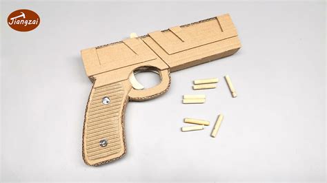 A person designing a cardboard gun