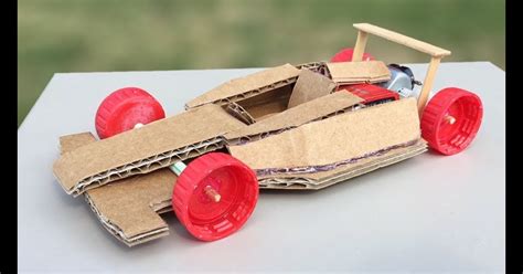 A child playing with a cardboard race car template