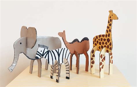 A set of cardboard wildlife templates, including a bird, monkey, and lion