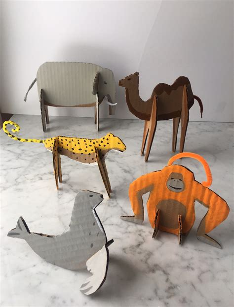 A set of cardboard zoo animal templates, including a giraffe, elephant, and zebra