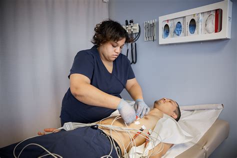 Cardiac technician performing test on patient