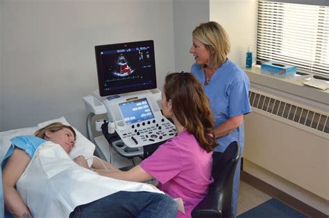 Cardiac technician working with patient