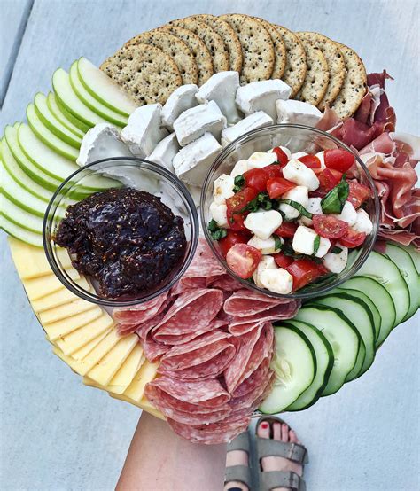 A charcuterie board with a variety of meats, cheeses, and crackers for a party