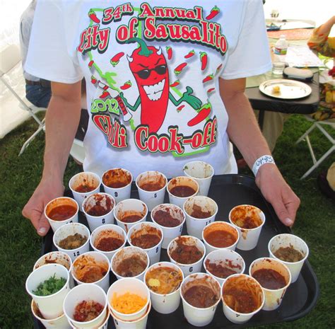 A judge taking a spoonful of chili, with a thoughtful expression