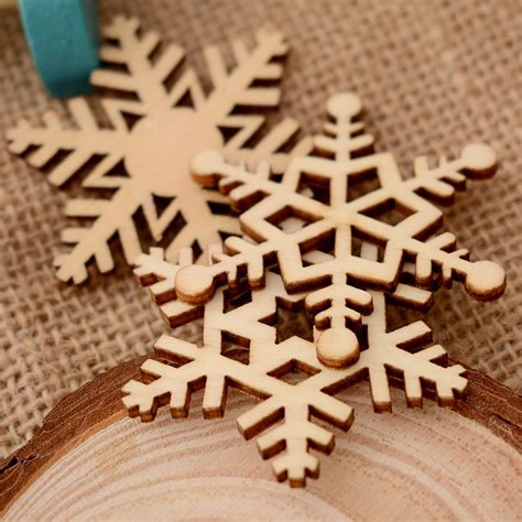 Wooden snowflake ornaments on a Christmas tree