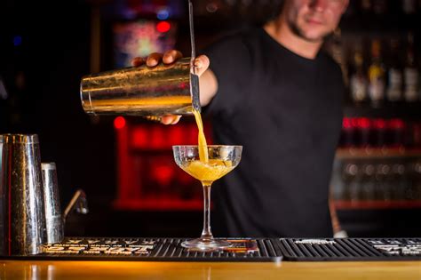 Bartender carefully crafting a classic cocktail