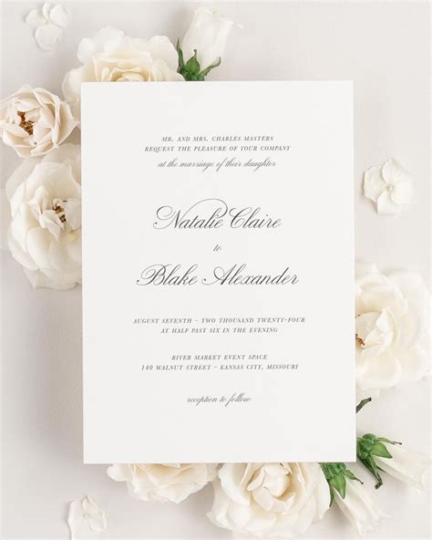 Classic script wedding invitation with floral pattern and ribbon