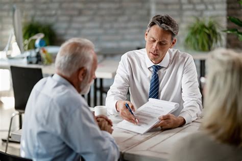 A lawyer speaking with a client in a conference room