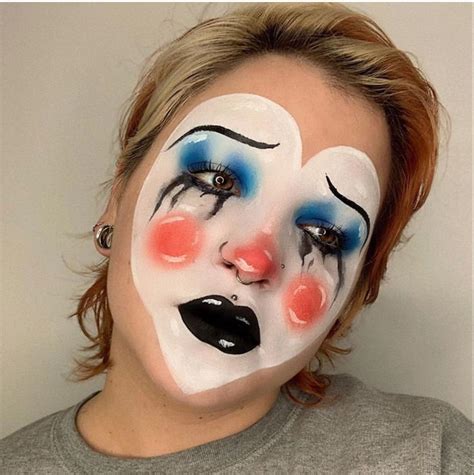 A clown applying makeup