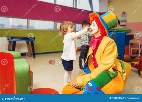 A clown playing with a child