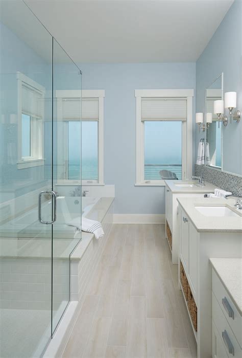 A coastal-inspired bathroom featuring a soothing color palette and ocean-inspired wall art.