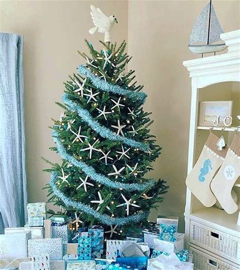 A coastal-themed tree with shells, driftwood, and blue ornaments