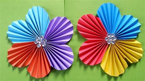 A selection of colorful paper crafts, including paper flowers and origami animals