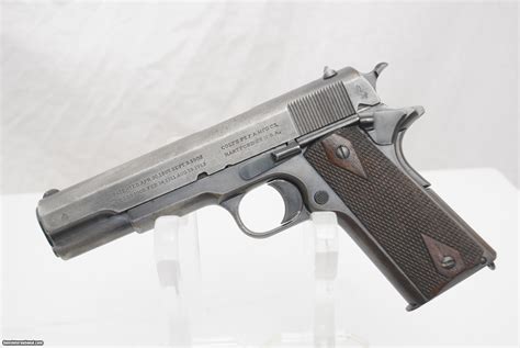 A Colt 1911 pistol with its slide and magazine removed