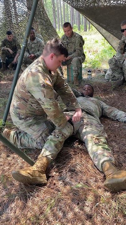 Combat medics administering medication to patients