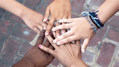 Image of a group of people from different backgrounds and cultures, smiling and embracing each other