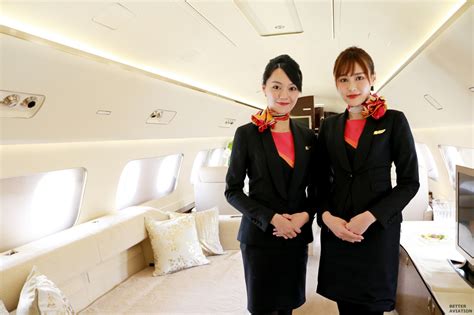 Corporate flight attendant serving refreshments on a private jet