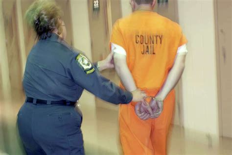 A Correctional Officer supervising inmates in a prison yard