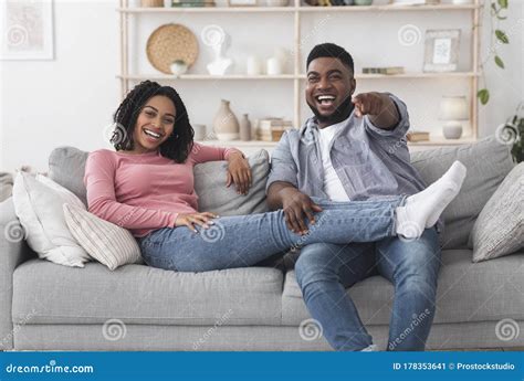 Couple laughing at TV show