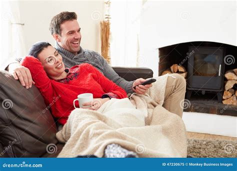 Couple relaxing while watching TV