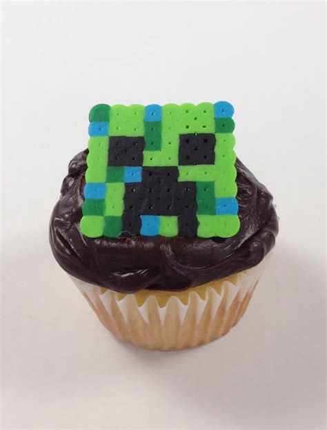 Creeper cupcake topper with a green and black design