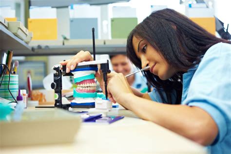 Dental lab technician working on a specialized dental appliance