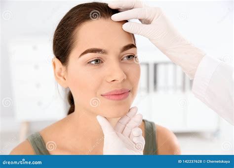 Dermatologist examining patient