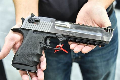 Desert Eagle pistol with a scale in the background