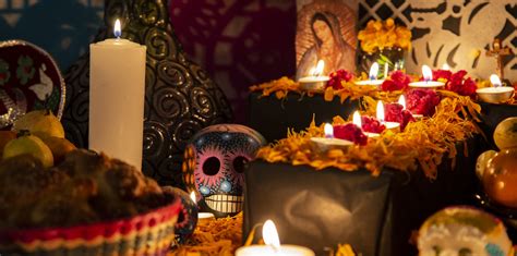 A family celebrating Día de Muertos with traditional decorations and food