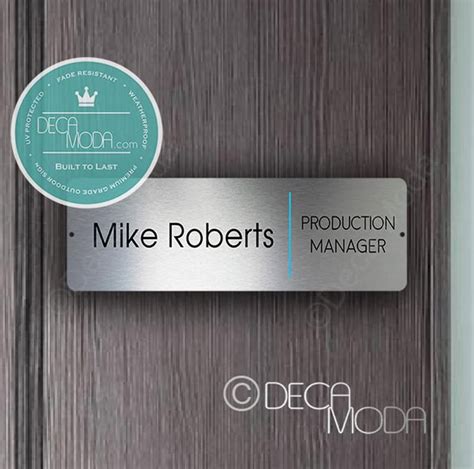 A person holding a customized door name plate