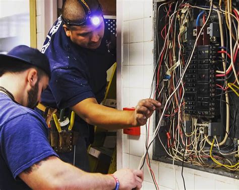 Electrical and electronics repairers at work