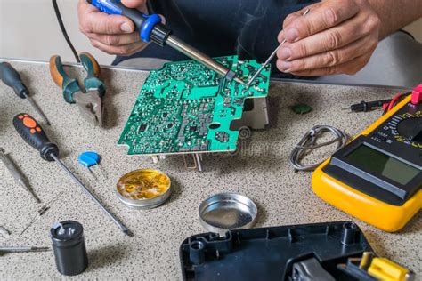 Electrical and electronics repairers working on automotive electronics